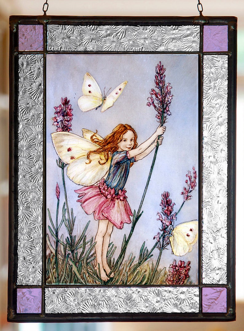 May include: A stained glass window featuring a fairy with wings holding a lavender stalk. The fairy has red hair and is wearing a blue and pink dress. There are two white butterflies in the image.
