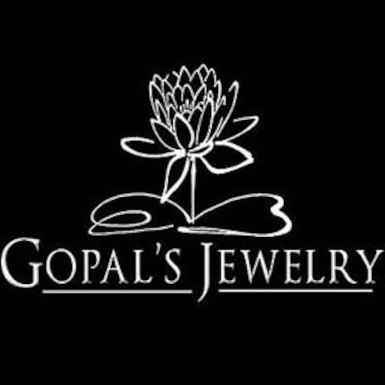 May include: A white lotus flower with a stem and leaves, with the text "GOPAL'S JEWELRY" below the flower.
