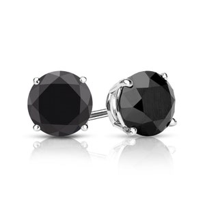 May include: A pair of black diamond stud earrings set in sterling silver.