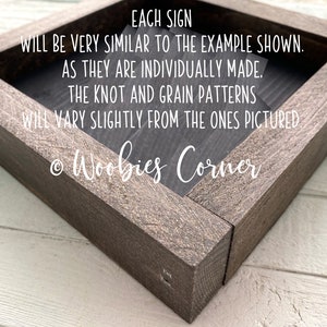 May include: A wooden sign with the text "EACH SIGN WILL BE VERY SIMILAR TO THE EXAMPLE SHOWN. AS THEY ARE INDIVIDUALLY MADE. THE KNOT AND GRAIN PATTERNS WILL VARY SLIGHTLY FROM THE ONES PICTURED &copy; Woobies Corner"