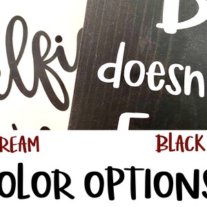 May include: Two wooden signs with the text "Selfie doesn't count" in black and white lettering. The signs are shown against a cream and black background. The text "CREAM" and "BLACK" are shown below the signs.