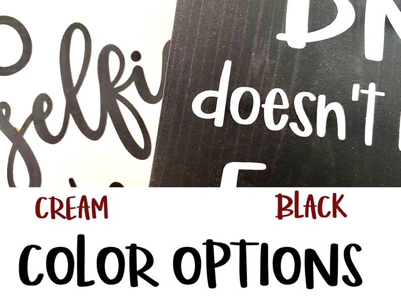 May include: Two wooden signs with the text "Selfie doesn't count" in black and white lettering. The signs are shown against a cream and black background. The text "CREAM" and "BLACK" are shown below the signs.