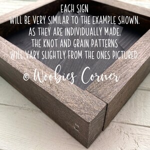 May include: A wooden sign with the text "EACH SIGN WILL BE VERY SIMILAR TO THE EXAMPLE SHOWN. AS THEY ARE INDIVIDUALLY MADE. THE KNOT AND GRAIN PATTERNS WILL VARY SLIGHTLY FROM THE ONES PICTURED &copy; Woobies Corner"