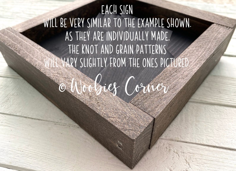 May include: A wooden sign with the text "EACH SIGN WILL BE VERY SIMILAR TO THE EXAMPLE SHOWN. AS THEY ARE INDIVIDUALLY MADE. THE KNOT AND GRAIN PATTERNS WILL VARY SLIGHTLY FROM THE ONES PICTURED &copy; Woobies Corner"