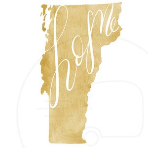 May include: A watercolor-style print of the state of Vermont in a golden hue. The word "home" is written in elegant white script across the state's outline. The background is white.