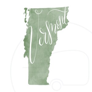 May include: A watercolor-style print of the state of Vermont in a muted green hue. The word "Vermont" is written in elegant white script across the state's outline. The background is white.