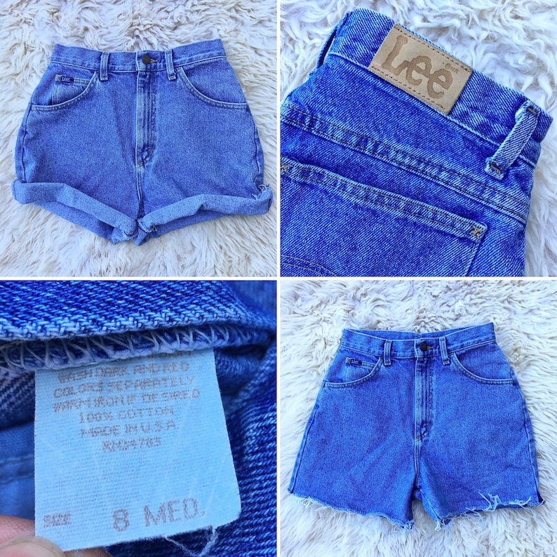 May include: Light blue denim shorts with a high waist and rolled cuffs. The shorts feature a classic five-pocket design and a Lee brand patch. The shorts are size 8 Med. Made in the USA.