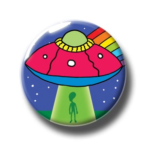 May include: A red and blue cartoon UFO with a rainbow trailing behind it, hovering over a green alien standing on a green field against a blue starry night sky.