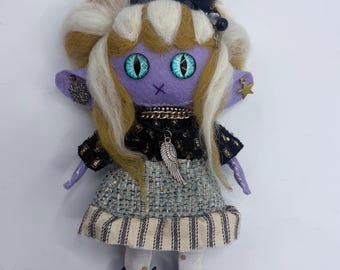 Handmade felt doll with black horns