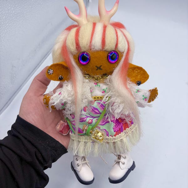 Handmade felt doll with antlers