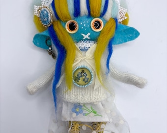 Handmade felt doll in blue and yellow