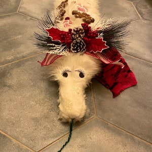 Plush holiday worm on a string