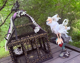 White crow sculpture with painted bird cage