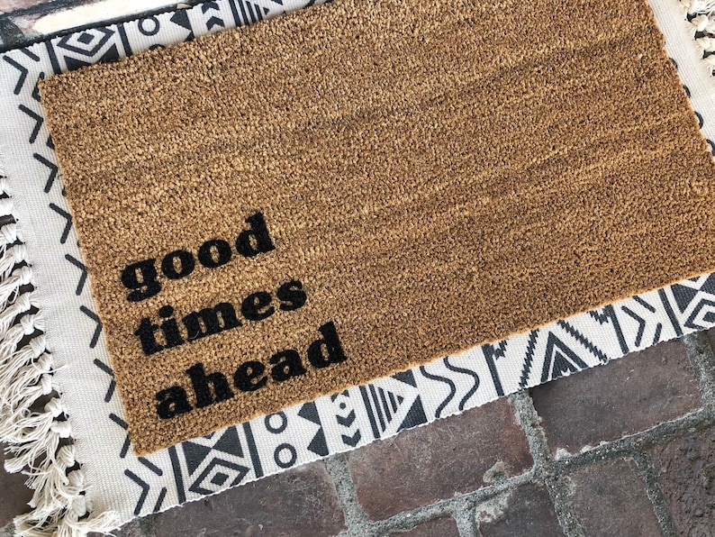 Good Times Ahead Doormat layered over a pretty Navajo patterned rug makes a charming impression at the front door. Come discover more French Farmhouse Decor inspired by Fixer Upper and click here to Get the Look of The Club House Kitchen & Sun Room. #fixerupper #joannagaines #kitchendecor #frenchfarmhouse