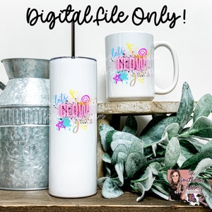 May include: Two white tumblers with a pink, blue, and yellow design that says "Let's Glow Girls". The tumblers are on a wooden shelf with a green plant in the background.