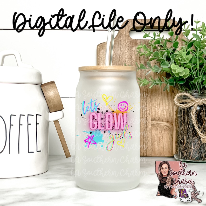 May include: A frosted glass tumbler with a bamboo lid and a straw. The tumbler has a pink, blue, and yellow graphic that says "Let's Glow Girls".
