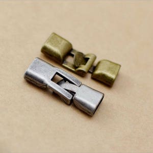 May include: Two metal clasps for jewelry making. One is silver and the other is gold.