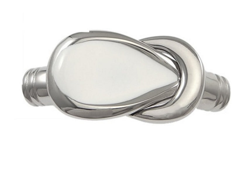 May include: A silver knot-shaped bracelet with a smooth, polished finish.