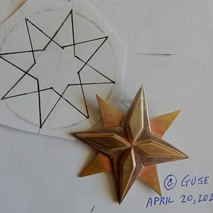 Original soldered eight point star. Four triangular points overlaid by four more points filling in between them. The top four points have a raised elongated diamond shape on top of them. Shown next to original design, copyright Guse, April 20, 2020