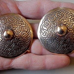 A Pair of Bronze Shield Brooches