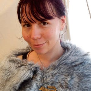 Customer shown wearing Master Ark's wolf brooch on cape.