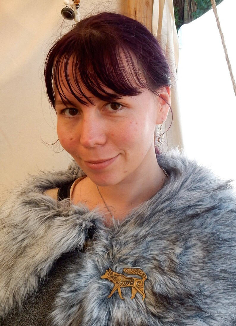 Customer shown wearing Master Ark's wolf brooch on cape.