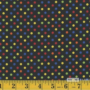 May include: Black fabric with a repeating pattern of small, colorful polka dots. The dots are red, yellow, blue, and green. A ruler is visible at the bottom of the image, with the numbers 1 through 8.