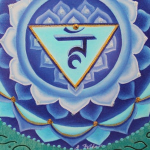 May include: A blue and gold mandala with a turquoise triangle and Sanskrit symbol in the center. The mandala is painted on a wooden surface.
