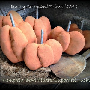 May include: A collection of six orange fabric pumpkins, with a rustic wooden bowl and the text "Pumpkin Bowl Fillers/Cupboard Tucks" and "Dusty Cupboard Prims 2014".
