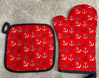 May include: A red oven mitt and a red pot holder with a white and blue anchor pattern.