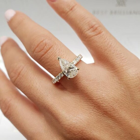 1.5 carat pear shaped diamond ring on hand
