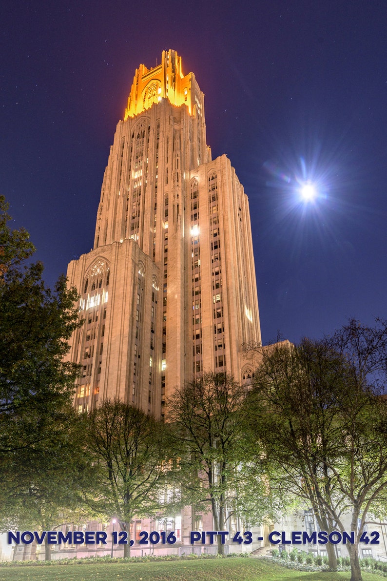 May include: A tall, illuminated building with a pointed roof against a night sky with stars and a bright moon. The building is made of stone and has many windows. The text "NOVEMBER 12, 2016 PITT 43 - CLEMSON 42" is visible at the bottom of the image.