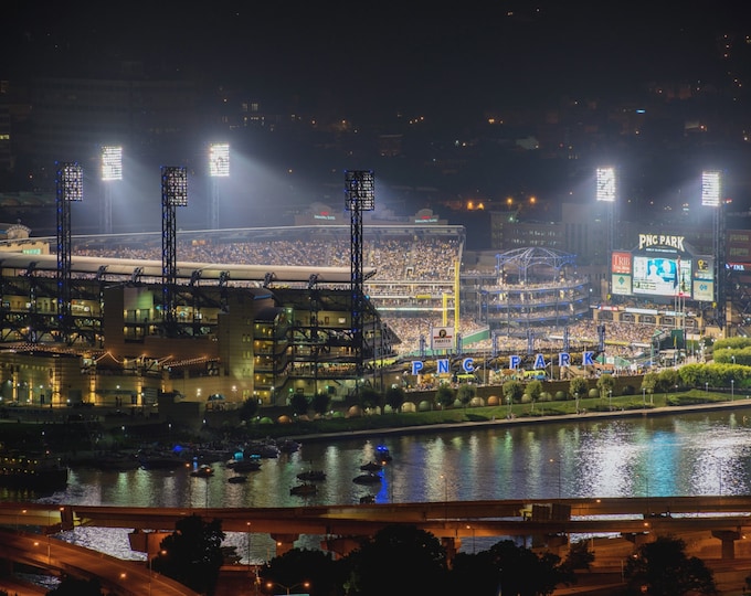 PNC Park is lit up at night during a Pittsburgh Pirates game - Metal Print