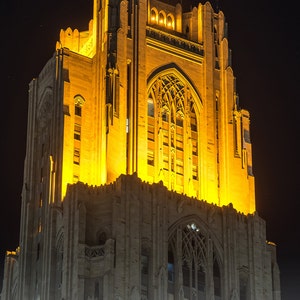 May include: A tall, illuminated building with a gothic architectural style. The building is lit up in a warm yellow light against a dark night sky. The text "SEPTEMBER 3, 2016 PITT 28 - VILLANOVA 7" is visible at the bottom of the image.