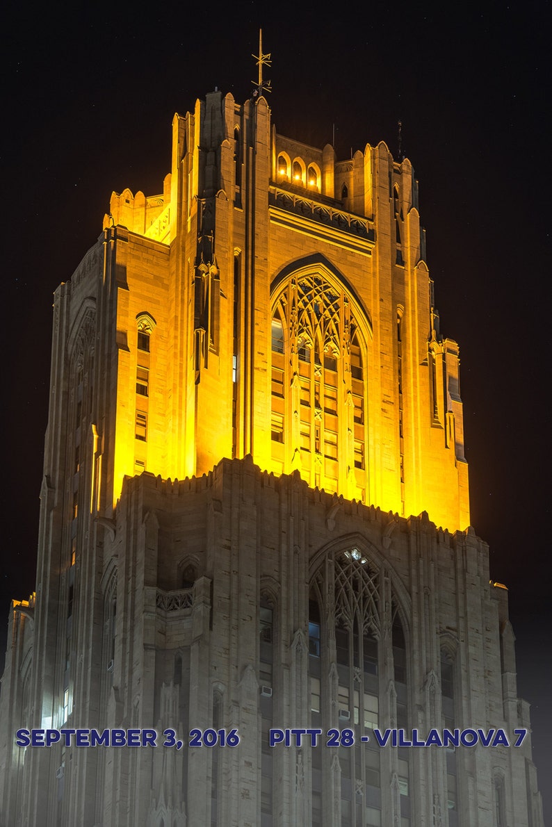 May include: A tall, illuminated building with a gothic architectural style. The building is lit up in a warm yellow light against a dark night sky. The text "SEPTEMBER 3, 2016 PITT 28 - VILLANOVA 7" is visible at the bottom of the image.