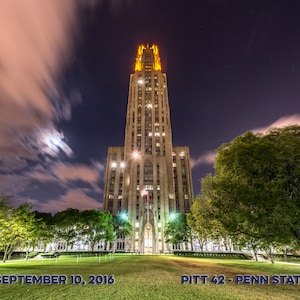 May include: A night view of a tall, illuminated building with a pointed roof. The building is surrounded by trees and a grassy area. The text "SEPTEMBER 10, 2016" and "PITT 42 - PENN STATE 39" is visible at the bottom of the image.