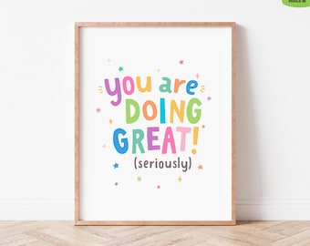 May include: A framed print with the words "You are DOING GREAT! (seriously)" in colorful, playful lettering. The print has a white background with colorful stars and accents, and is set in a light brown frame.
