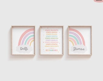 May include: Three framed wall art prints with light wood frames. The outer prints feature a pastel rainbow over a cloud with the names Delfi and Stiorra. The center print contains the Spanish text: SOMOS VALIENTES, AMADAS, FELICES, FUERTES, HONESTAS, AMABLES, HERMOSAS, ATENTAS, SUFICIENTE, HERMANAS.