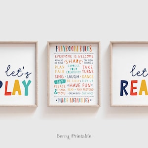May include: Three framed prints with colorful text. The left print says "let's play" in large, colorful letters. The right print says "let's read" in large, colorful letters. The center print has a list of "Playroom Rules" in colorful text.