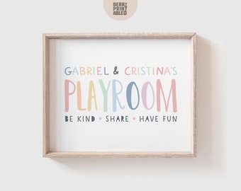 May include: A framed print with the text "Gabriel & Cristina's Playroom" in rainbow colors. The text "Be Kind. Share. Have Fun" is printed below in black.