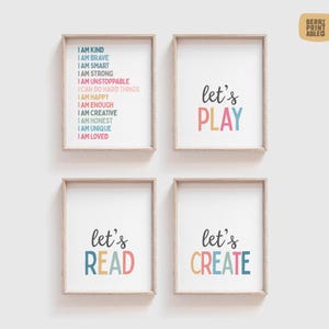 May include: Four framed prints with white backgrounds and text. One print says "I AM KIND, I AM BRAVE, I AM SMART, I AM STRONG, I AM UNSTOPPABLE, I CAN DO HARD THINGS, I AM HAPPY, I AM ENOUGH, I AM CREATIVE, I AM HONEST, I AM UNIQUE, I AM LOVED". The other three say "let's PLAY", "let's READ", and "let's CREATE".