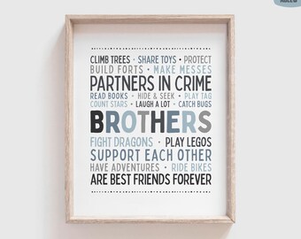 May include: A framed wall art print featuring the text 'Brothers' in large, bold letters, surrounded by smaller phrases like 'Partners in Crime', 'Climb Trees', 'Build Forts', and 'Are Best Friends Forever' in shades of blue, gray, and black.