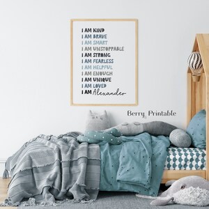 May include: A framed printable with a blue and gray color scheme. The text reads "I am kind, I am brave, I am smart, I am unstoppable, I am strong, I am fearless, I am helpful, I am enough, I am unique, I am loved, I am Alexander".
