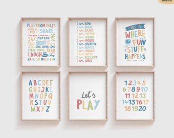May include: Six framed prints with colorful text. The prints include phrases like "Playroom Rules," "I am Kind," and "This is Where the Fun Stuff Happens." Other prints display the alphabet, numbers 1-20, and the words "Let's PLAY."