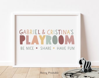 May include: A white framed print with the text "Gabriel & Cristina's Playroom" in colorful letters. The text "Be Nice. Share. Have Fun" is below the main text.