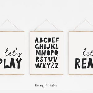 May include: Three black and white printable wall art prints with the text "let's play", the alphabet, and "let's read".