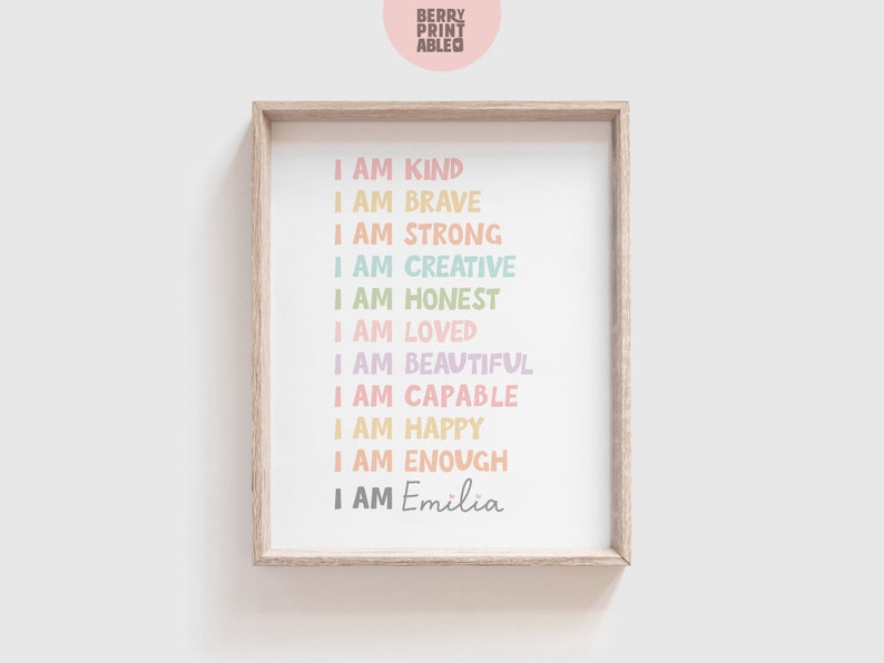 May include: A framed print with a white background and colorful text that reads "I am kind, I am brave, I am strong, I am creative, I am honest, I am loved, I am beautiful, I am capable, I am happy, I am enough, I am Emilia".