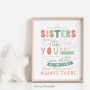 May include: A printable wall art print with a quote about sisters. The quote reads "Sisters are like stars. You don't always see them, but you know that they are always there." The print has a light pink background with colorful lettering.