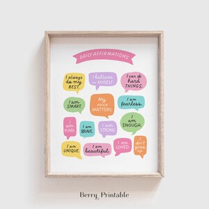 May include: A printable poster with the text "DAILY AFFIRMATIONS" in pink at the top. The poster features 12 colourful speech bubbles with positive affirmations, such as "I always do my best", "I believe in myself", "I am smart", "My voice matters", "I am fearless", "I am kind", "I am brave", "I am strong", "I am enough", "I am unique", "I am beautiful", and "I am loved". The poster is framed in a light wood frame.