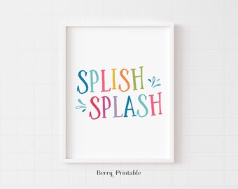 Puede incluir: Una impresión enmarcada en blanco con el texto "Splish Splash" en letras de colores. Las letras son de diferentes colores, incluyendo rosa, azul, verde, amarillo y naranja. El texto está en una fuente lúdica y es perfecto para un baño o una guardería.
